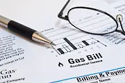 Close up of gas bill with pen and glasses