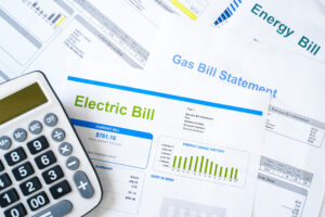 close up of electric and other bills with calculator
