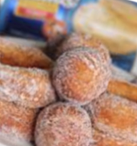 Close up of fried, sugar coated donuts and donut holes