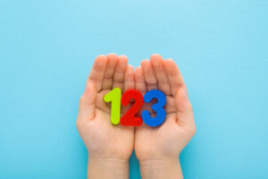 Hands holding numbers 1, 2, 3