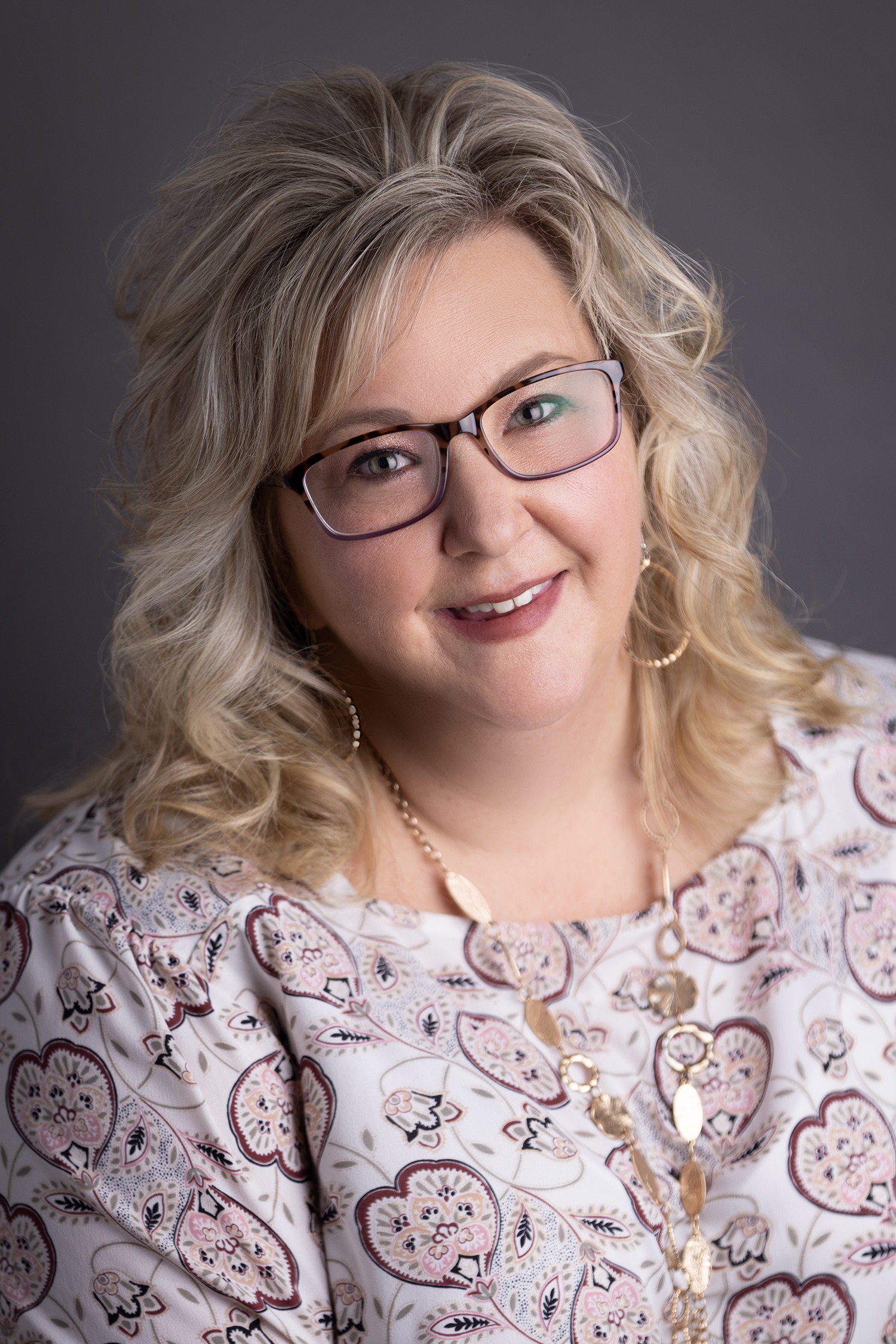 Head shot of blonde woman with glasses