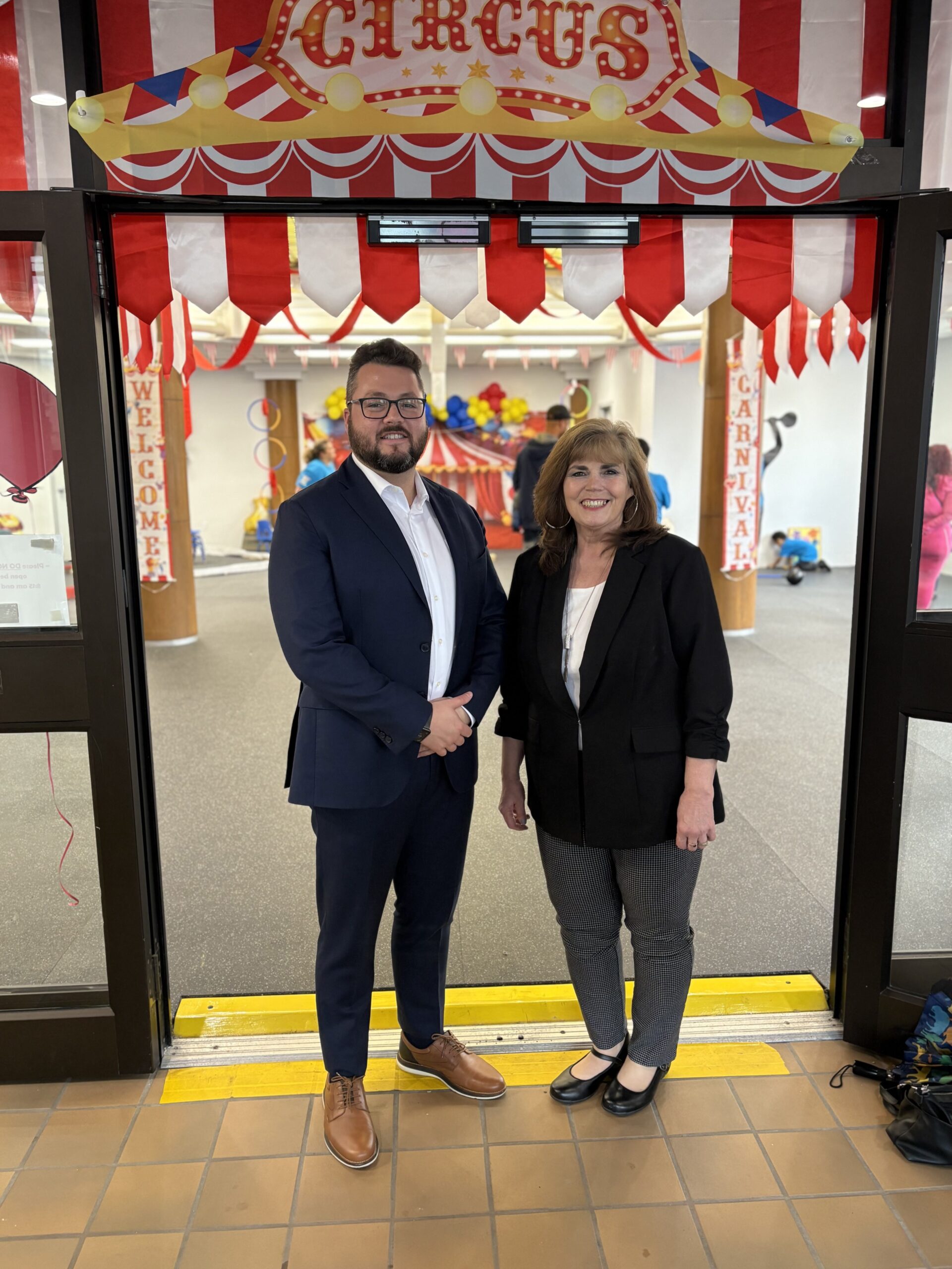 Two adults posing in a preschool