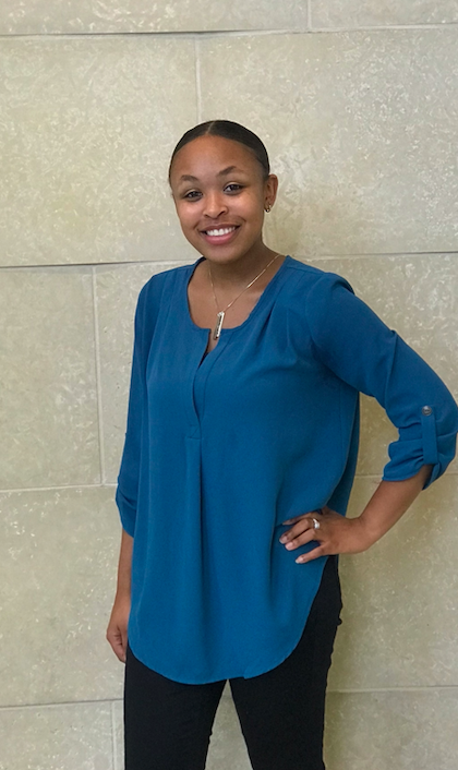 Black woman standing in front of wall