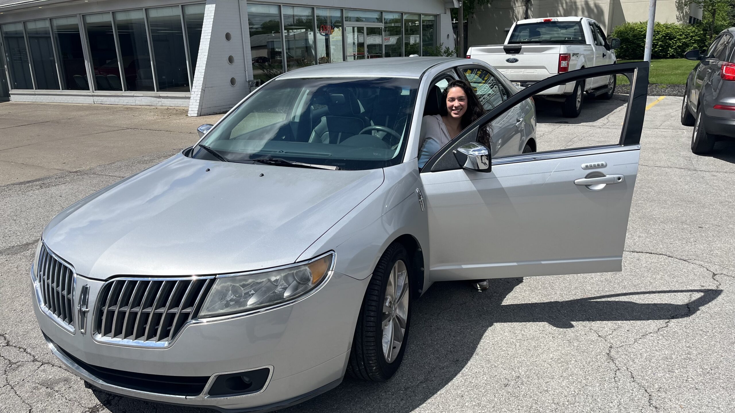 Black woman getting into silver car