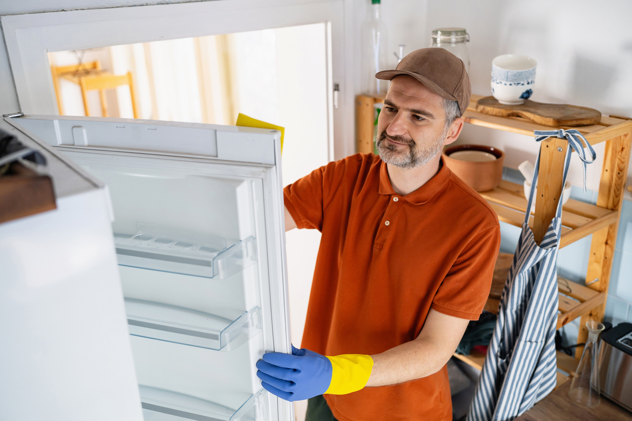 White man installing refrigerator
