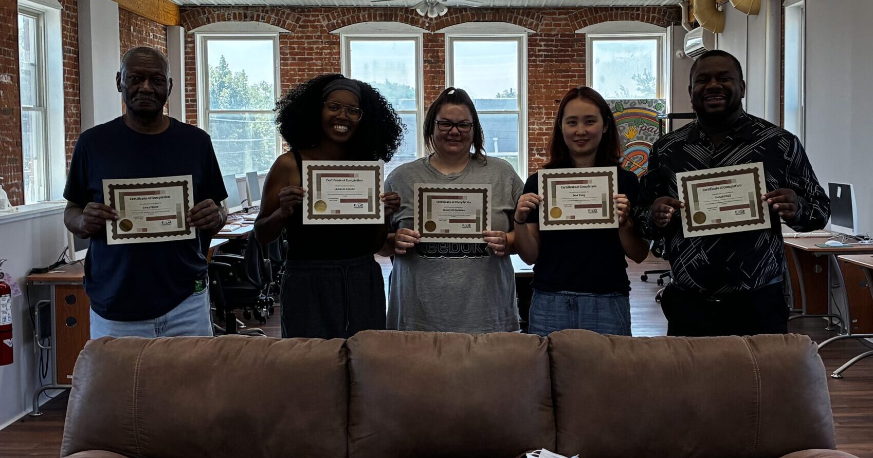 Group of people holding certificates