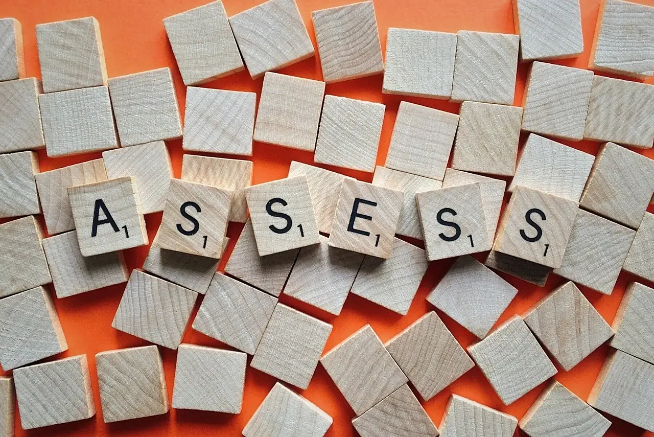 Assess spelled out in scrabble tiles