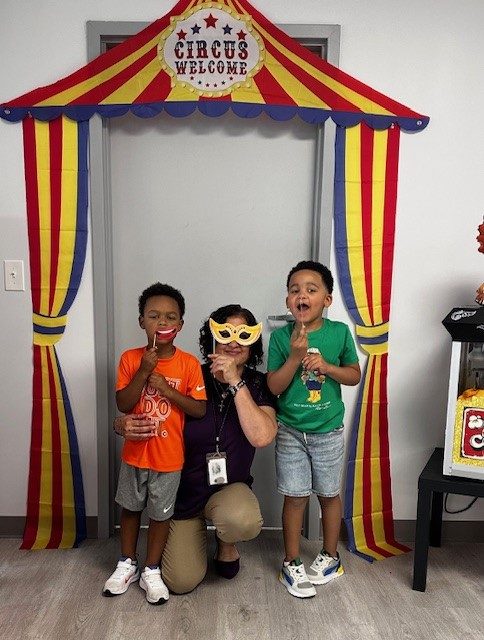 Bridging 7 Three preschoolers in front of a circus tent